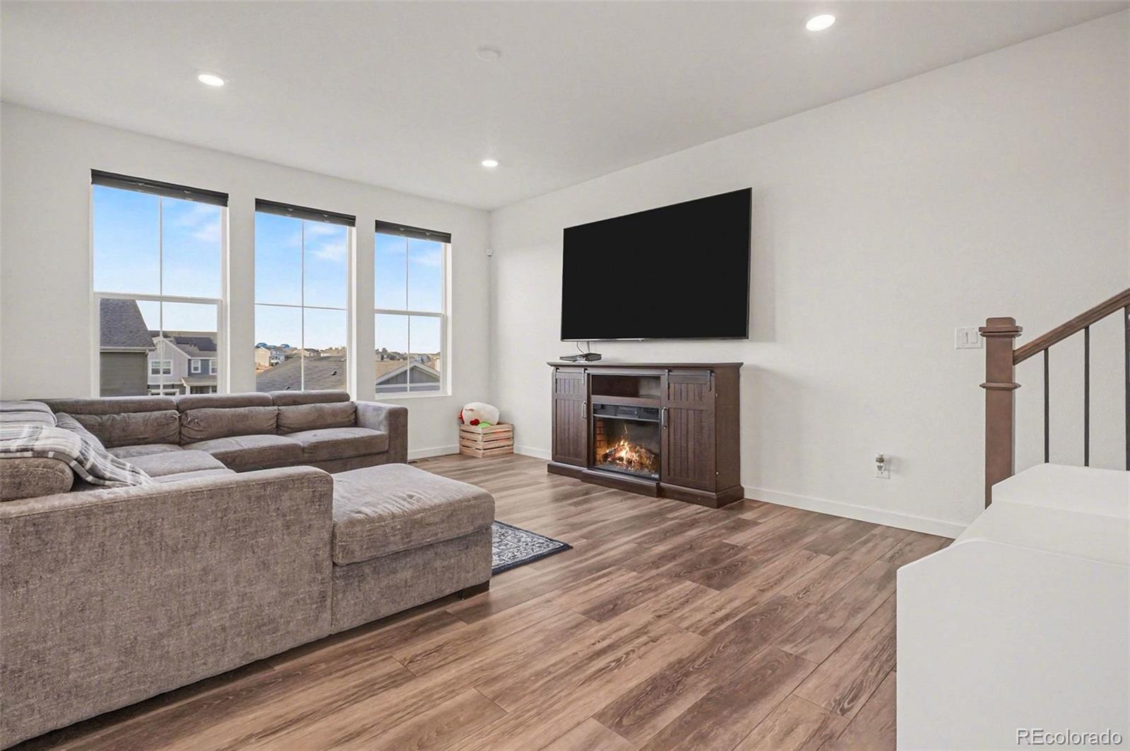 1053 Highpoint Trail Elizabeth, CO 80107 - Photo 5 of 28 a living room with fireplace furniture and a flat screen tv