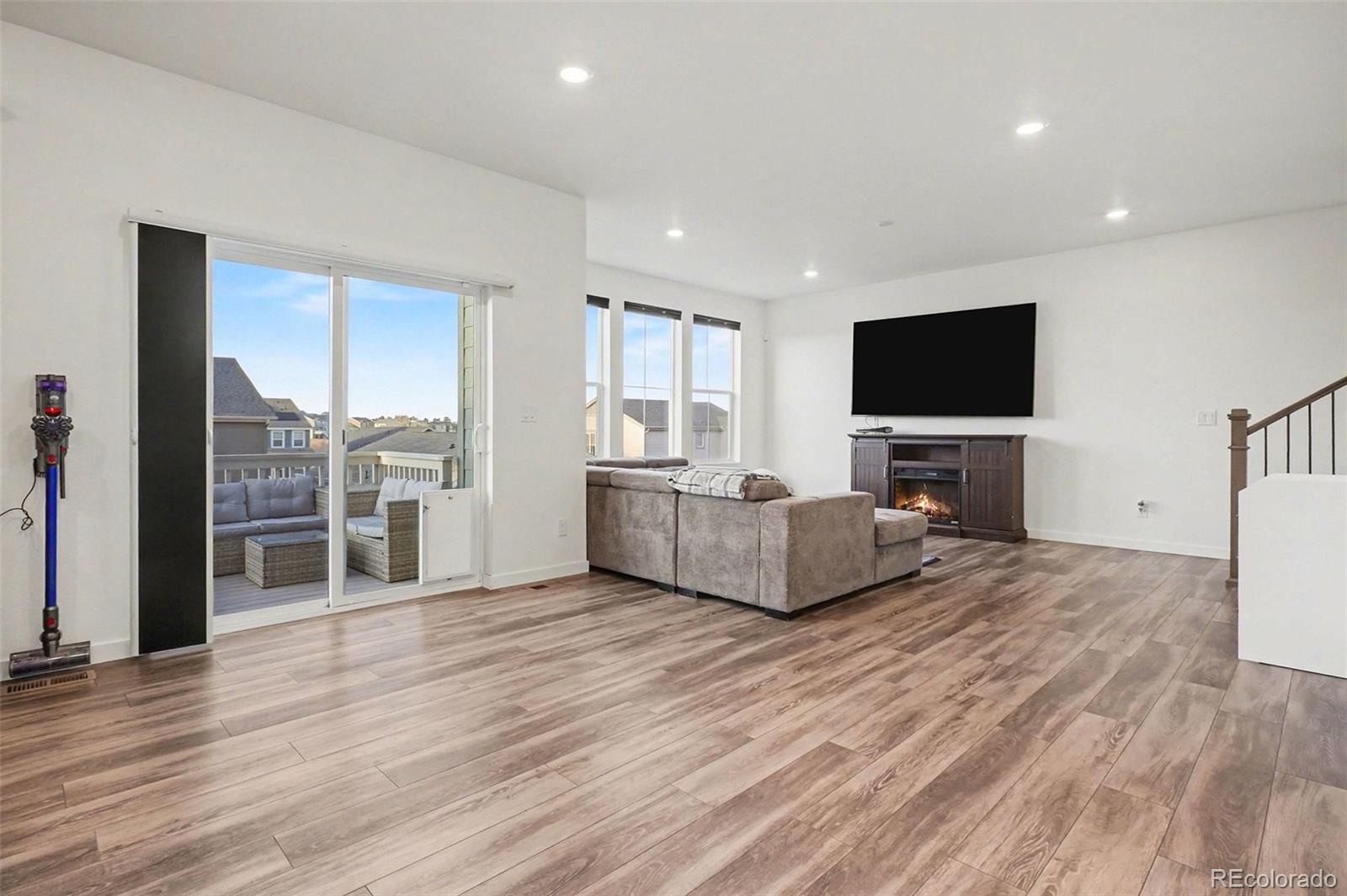 1053 Highpoint Trail Elizabeth, CO 80107 - Photo 6 of 28 a living room with furniture flat screen tv and a fireplace