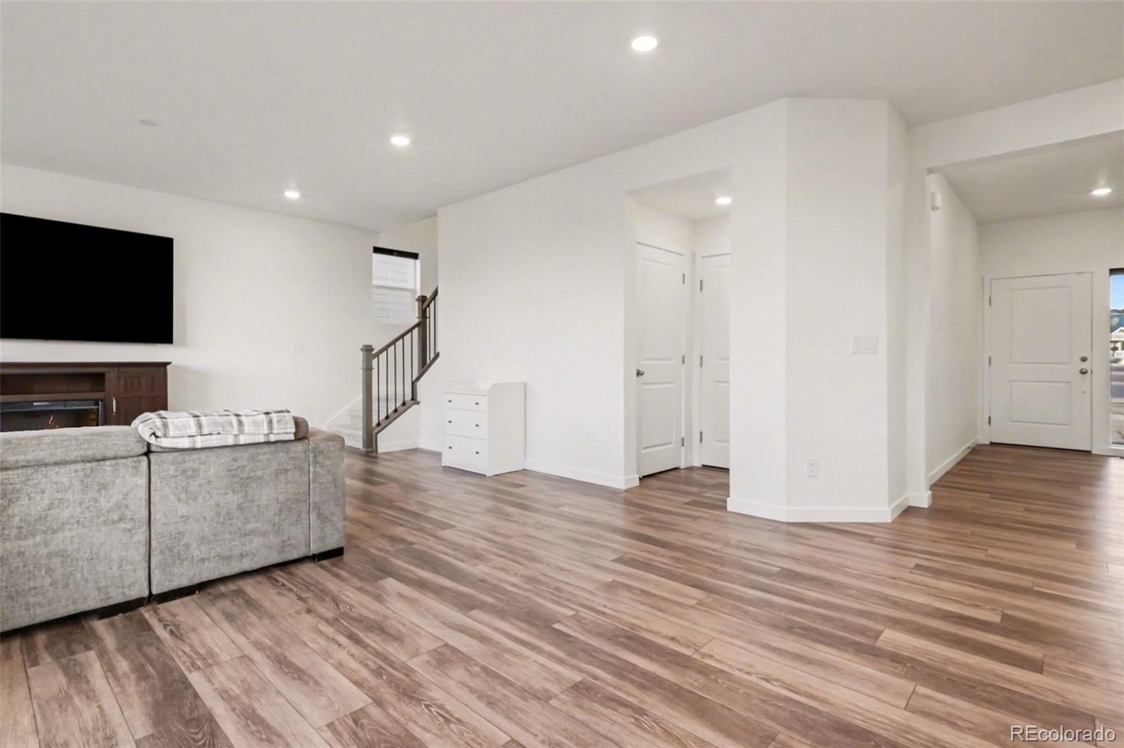 1053 Highpoint Trail Elizabeth, CO 80107 - Photo 9 of 28 a view of a livingroom with wooden floor and furniture
