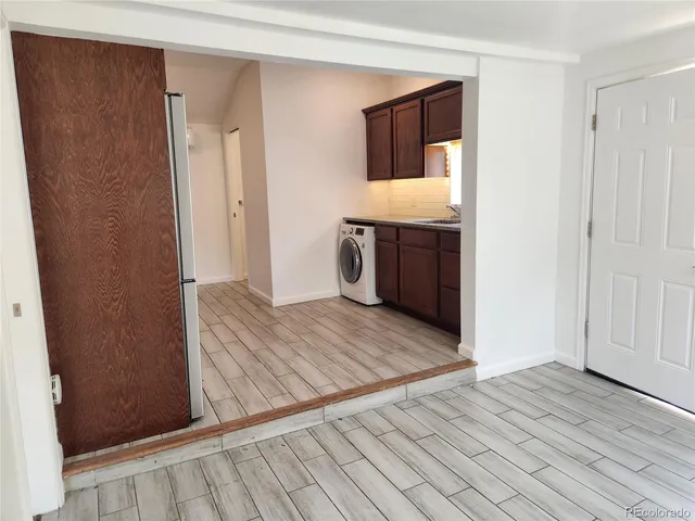 a view of hallway with wooden floor