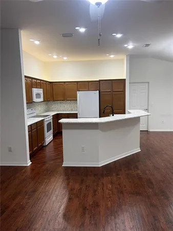 a kitchen with stainless steel appliances wooden cabinets a sink and a stove