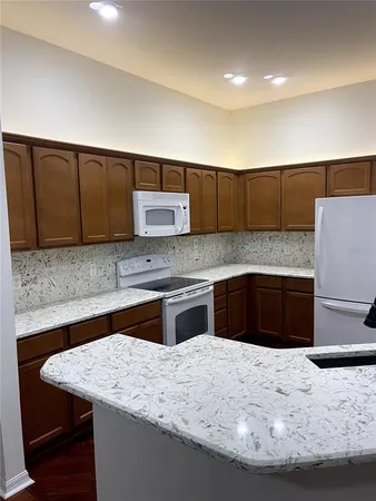 a kitchen with a refrigerator and a sink