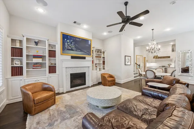 a kitchen with kitchen island a counter top space a sink a refrigerator a stove and a window