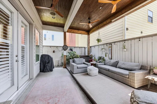 a living room with furniture fireplace and a large window