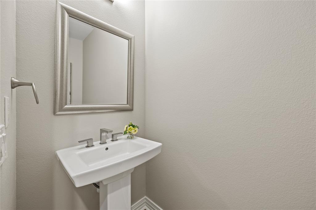 10409 Countryside Drive Denton, TX 76207 - Photo 21 of 38 1/2 Bathroom featuring a Pedestal Sink