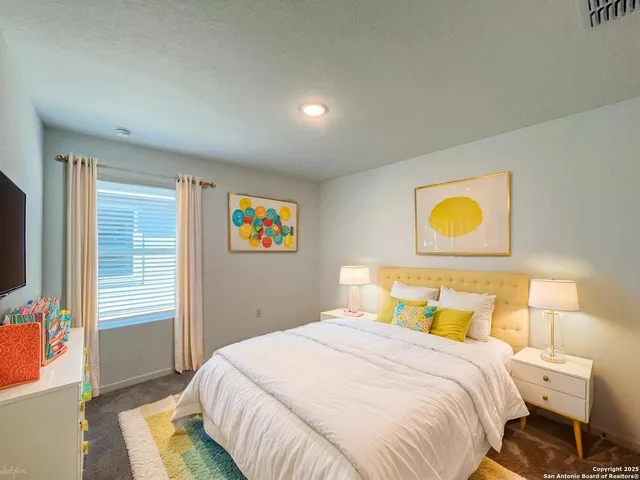 a bedroom with a bed and a television