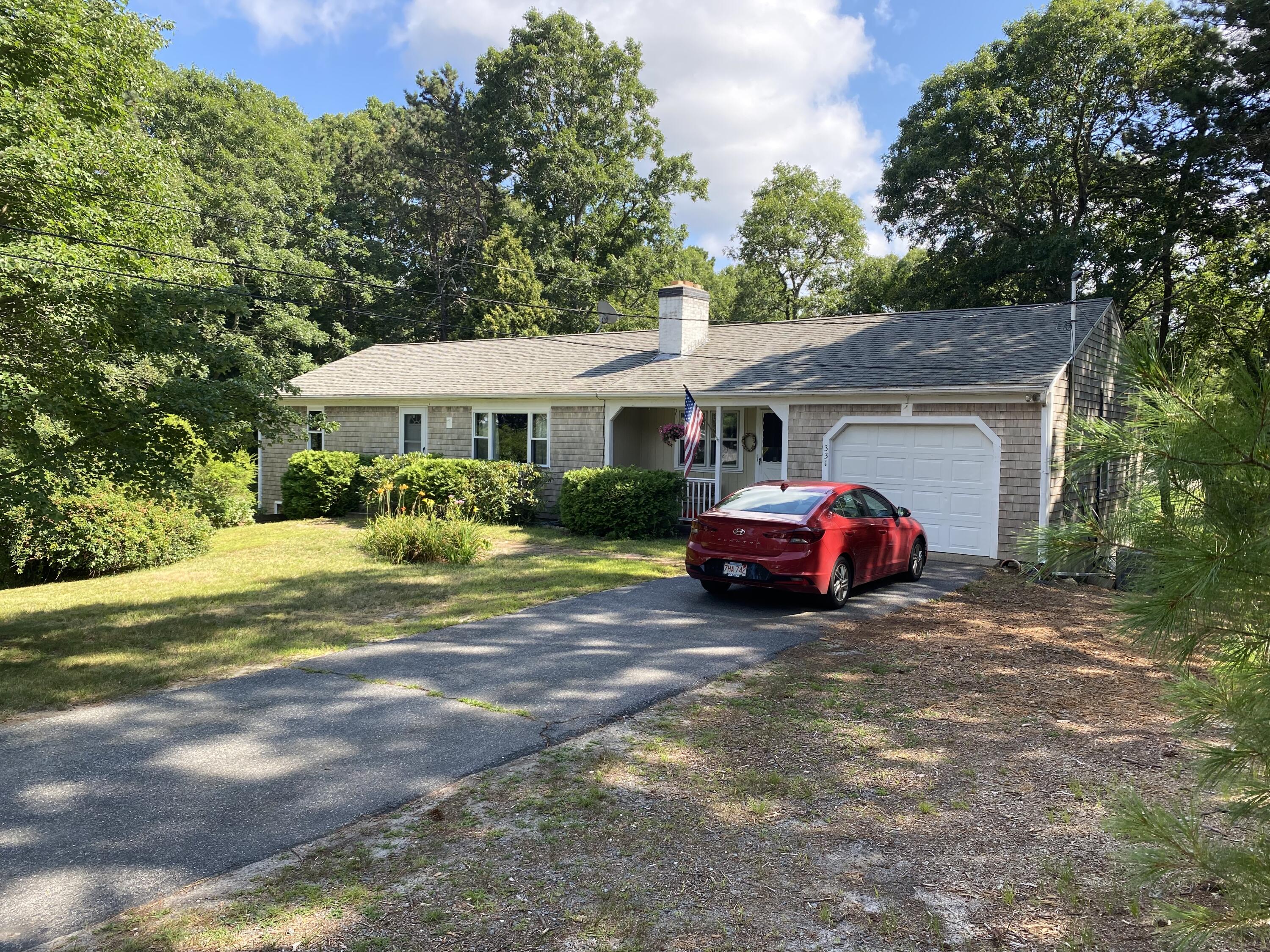 331 Ames Way Centerville, MA 02632 - Photo 1 of 16 a view of a house with a cars park side of a road