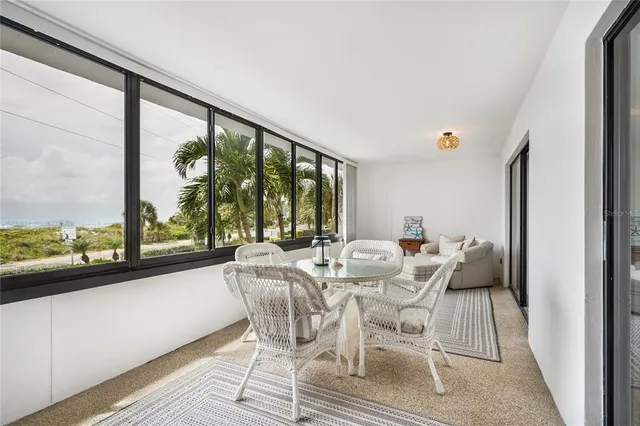 a living room with a large window and a table