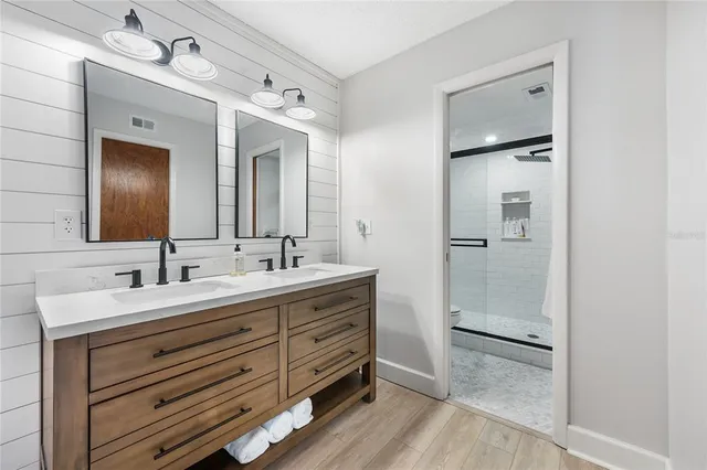 a bathroom with a double vanity sink and a mirror