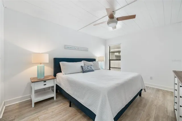 a bedroom with a bed and a night stand