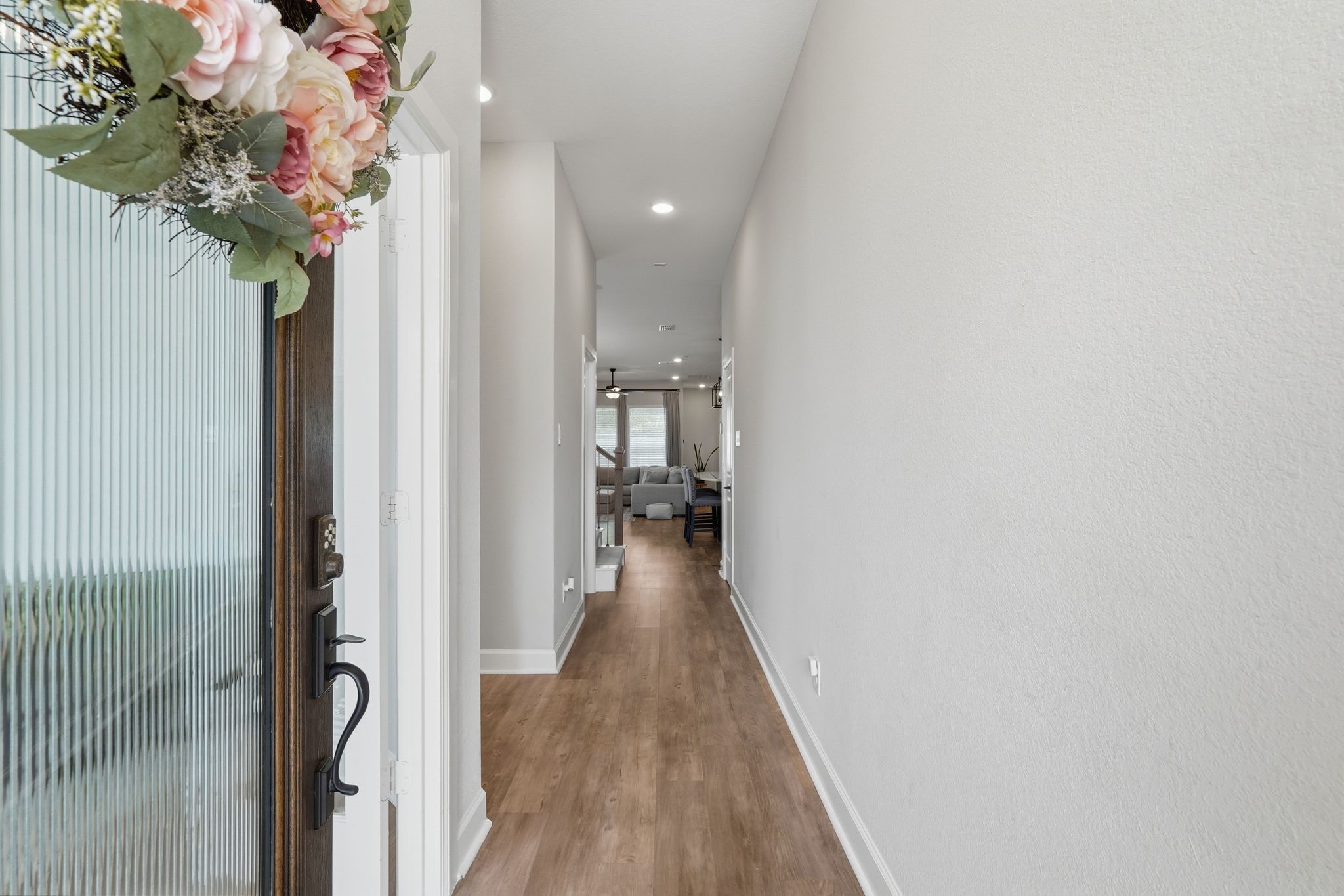 24423 Morningside Terrace Tomball, TX 77375 - Photo 12 of 47 a view of a hallway with wooden floor and staircase