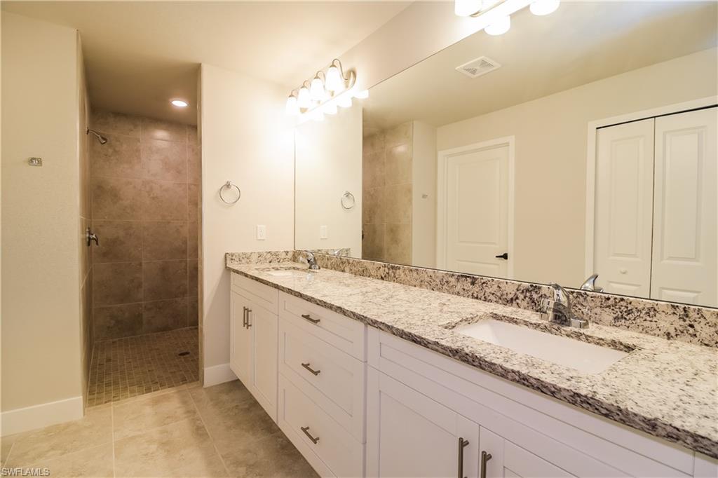 1004 Anson Avenue Lehigh Acres, FL 33971 - Photo 11 of 15 a bathroom with a granite countertop sink mirror and double