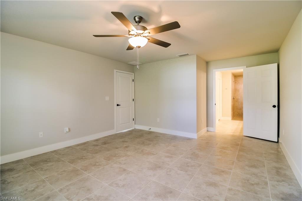 1004 Anson Avenue Lehigh Acres, FL 33971 - Photo 13 of 15 an empty room with closet and a ceiling fan