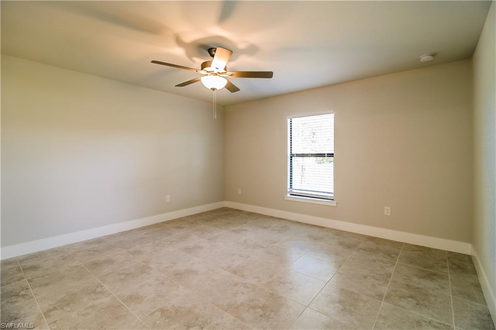 1004 Anson Avenue Lehigh Acres, FL 33971 - Photo 14 of 15 an empty room with windows and fan