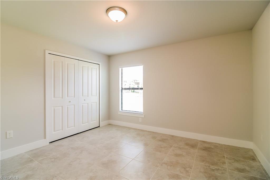 1004 Anson Avenue Lehigh Acres, FL 33971 - Photo 8 of 15 an empty room with windows