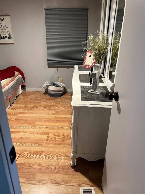 2334 San Bar Road, Unit 54 Graford, TX 76449 - Photo 16 of 28 a room with water heater and wooden floor