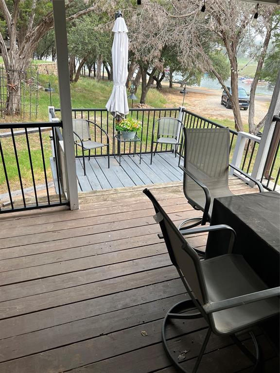 2334 San Bar Road, Unit 54 Graford, TX 76449 - Photo 19 of 28 a view of balcony with wooden floor and outdoor seating