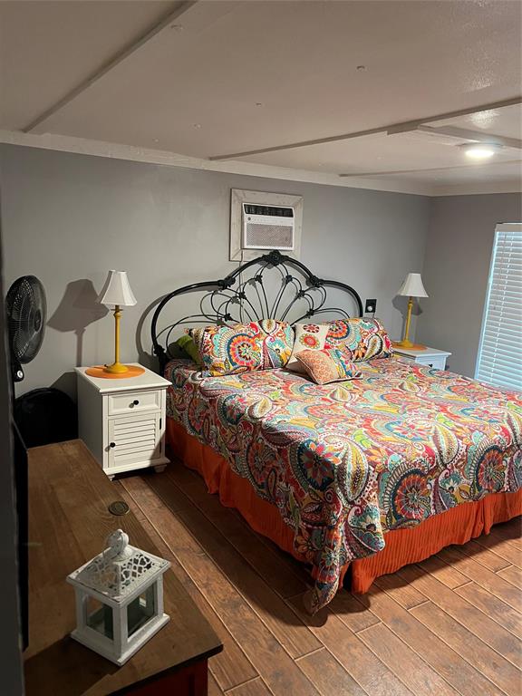 2334 San Bar Road, Unit 54 Graford, TX 76449 - Photo 8 of 28 a bedroom with a bed next to a window and dresser