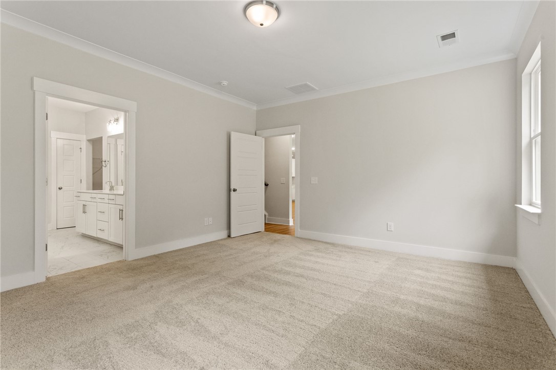 315 Old Shirley Road Central, SC 29630 - Photo 17 of 26 This spacious bedroom offers ample natural light and plush carpeting, with convenient access to the adjoining bathroom.