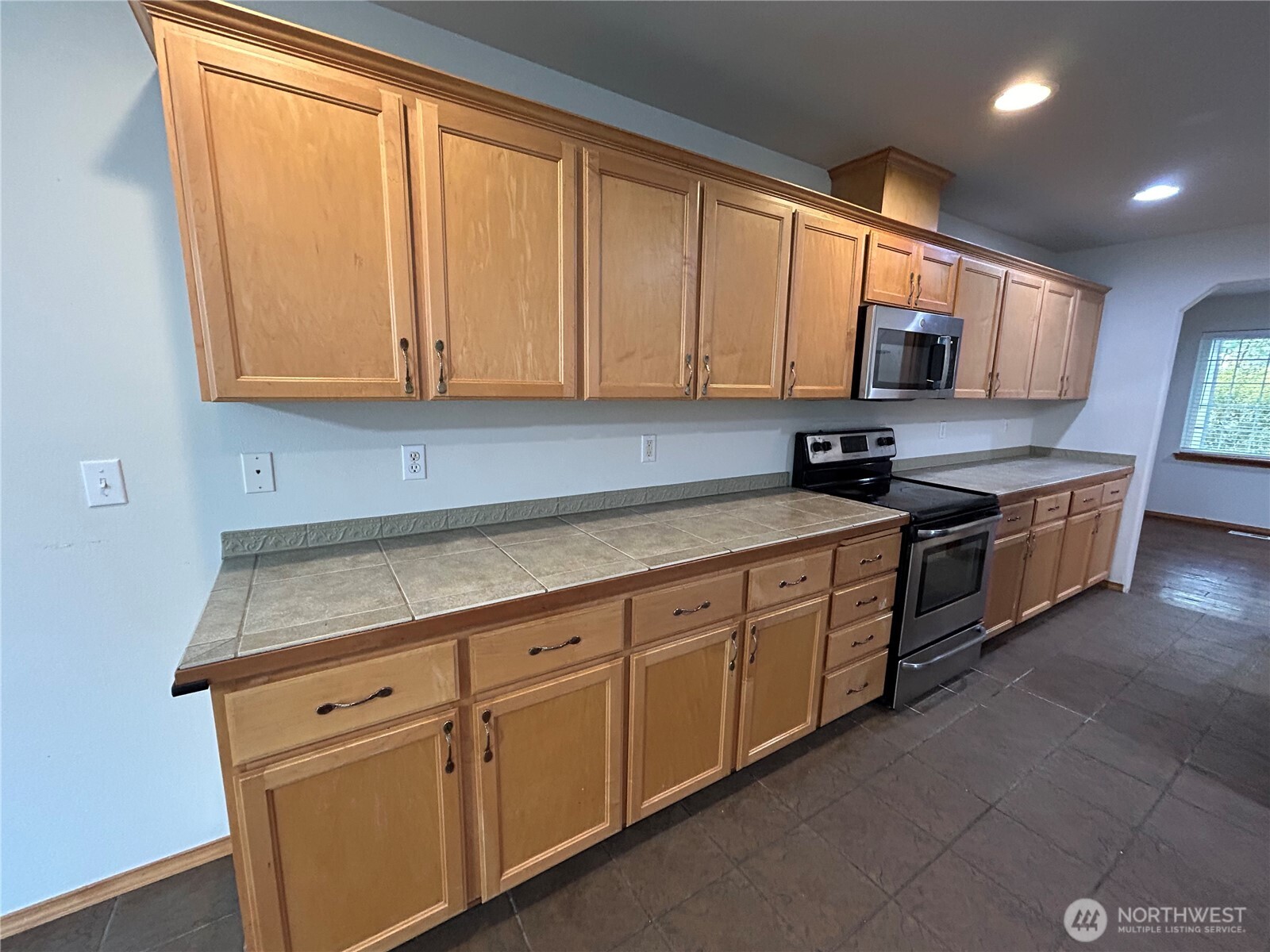 31114 29th Court Southwest Federal Way, WA 98023 - Photo 12 of 40 a kitchen with stainless steel appliances granite countertop a sink a stove and cabinets