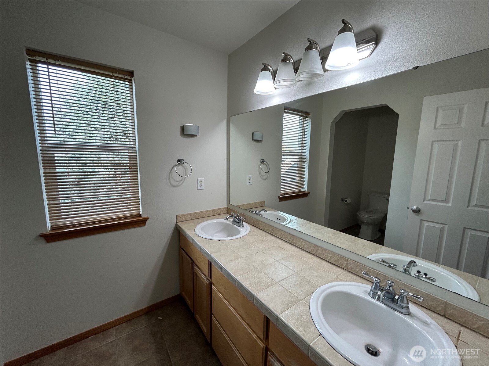 31114 29th Court Southwest Federal Way, WA 98023 - Photo 22 of 40 a bathroom with a granite countertop sink a large mirror and a shower