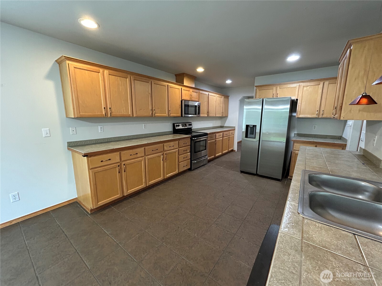 31114 29th Court Southwest Federal Way, WA 98023 - Photo 9 of 40 a kitchen with stainless steel appliances granite countertop a refrigerator sink and stove