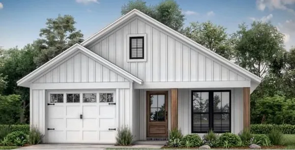 a view of a house with a yard and potted plants