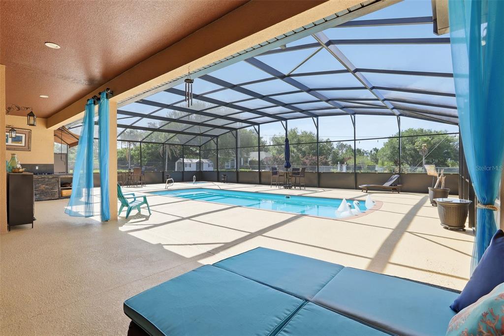 13429 Montevista Road Clermont, FL 34711 - Photo 58 of 89 a view of a patio with a table and chairs under an umbrella