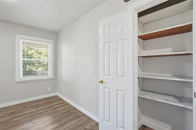 a view of walk in closet with empty racks