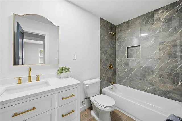 a bathroom with a sink a toilet and a bathtub