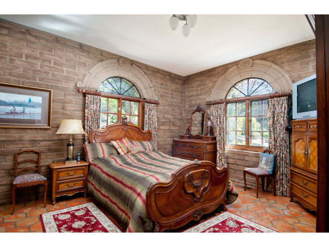 8 Mentone Road Carmel Highlands, CA 93923 - Photo 18 of 19 a bedroom with a bed window and a dresser in it