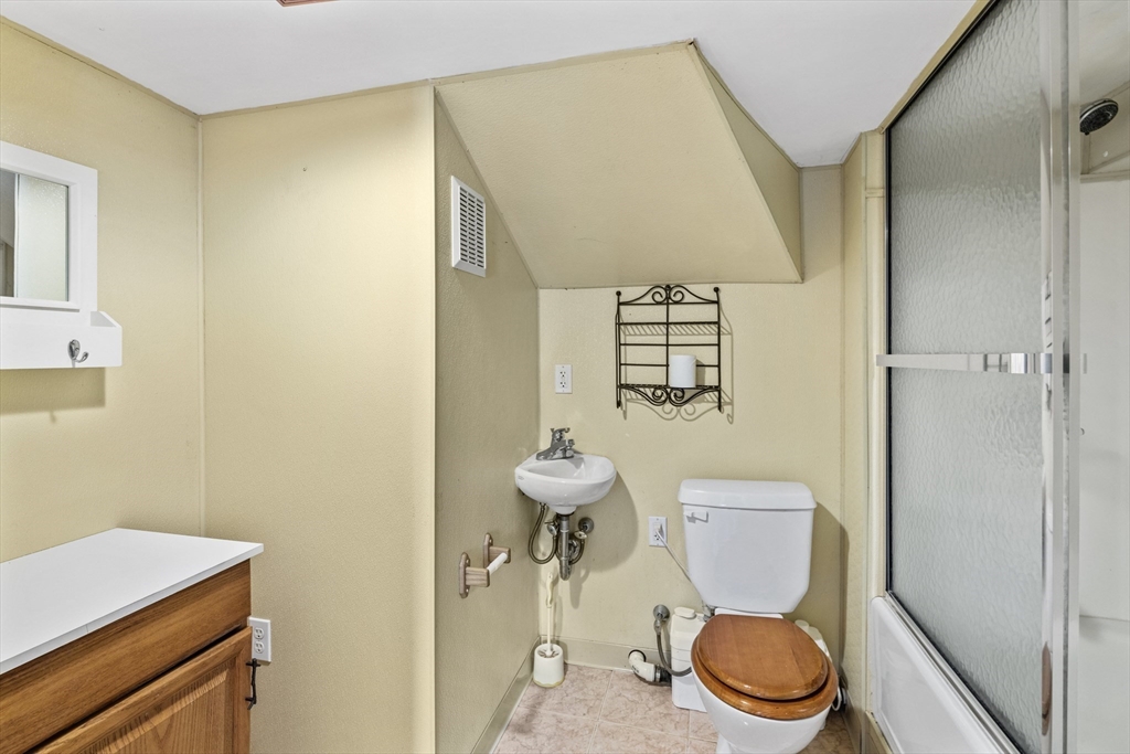 30 Haley Road, Unit 1 Marblehead, MA 01945 - Photo 17 of 21 a bathroom with a toilet a sink and a mirror