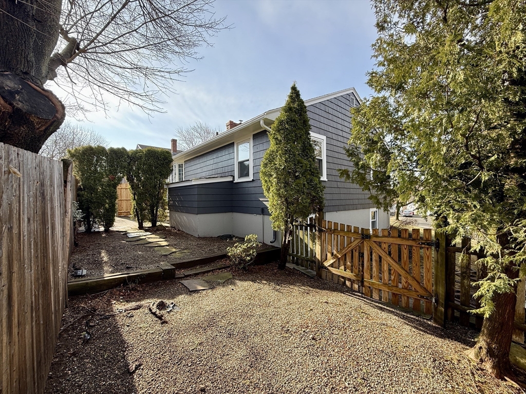 30 Haley Road, Unit 1 Marblehead, MA 01945 - Photo 19 of 21 a backyard of a house with barbeque oven table and chairs