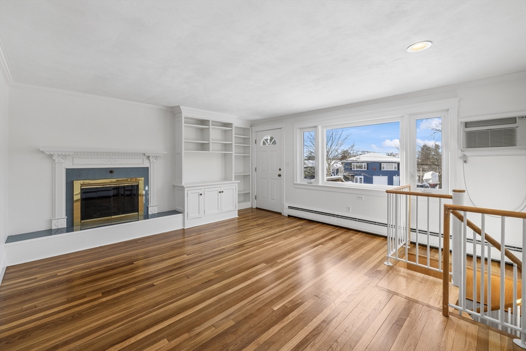 30 Haley Road, Unit 1 Marblehead, MA 01945 - Photo 3 of 21 a view of empty room with wooden floor and fireplace