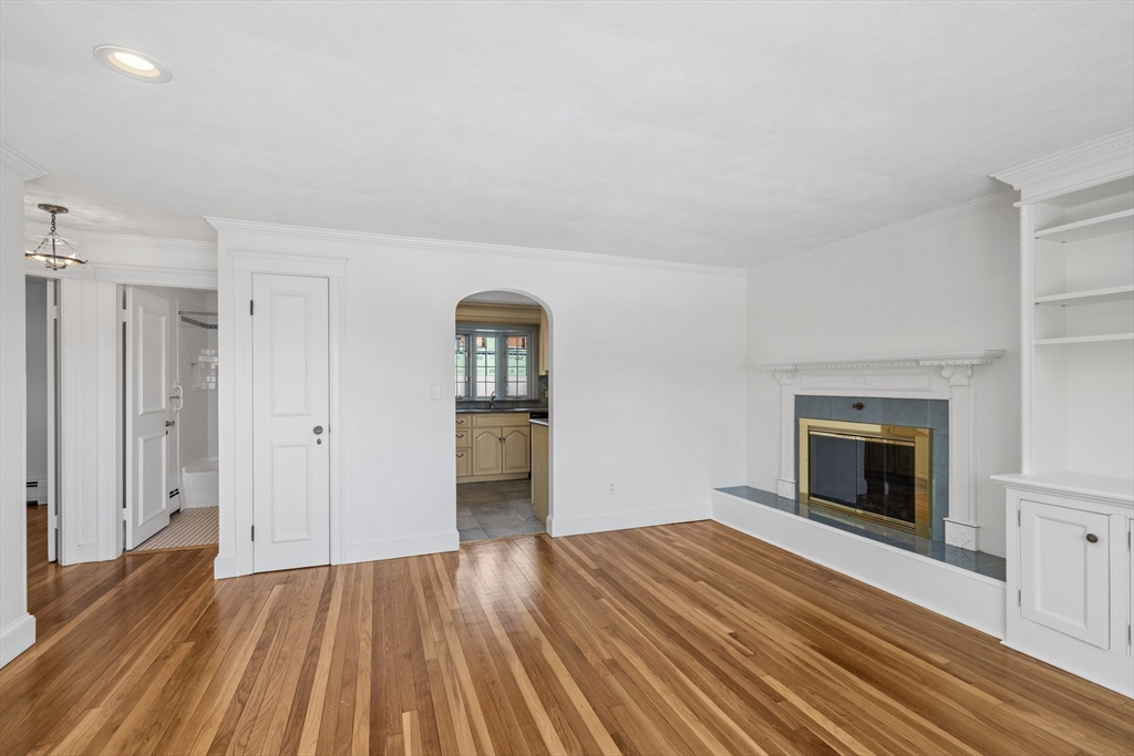 30 Haley Road, Unit 1 Marblehead, MA 01945 - Photo 4 of 21 a view of empty room with wooden floor and fireplace