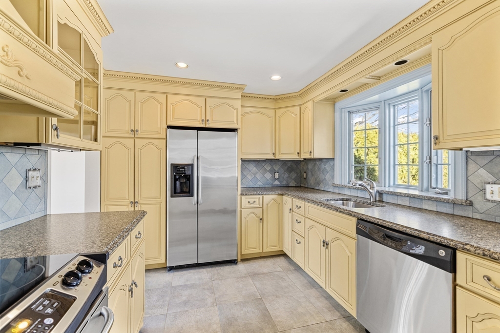 30 Haley Road, Unit 1 Marblehead, MA 01945 - Photo 6 of 21 a kitchen with stainless steel appliances granite countertop a sink and a refrigerator
