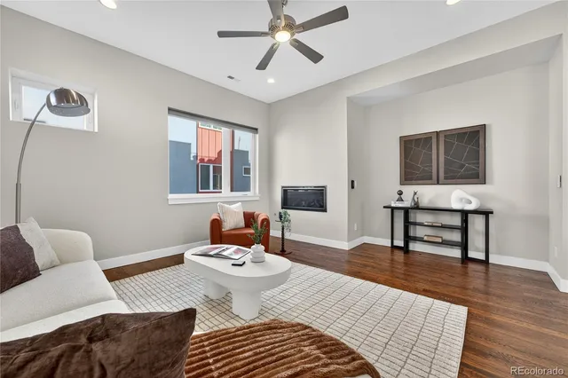 a living room with furniture and wooden floor