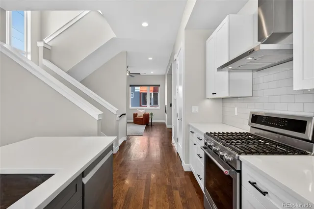 a kitchen with a stove and a white cabinets