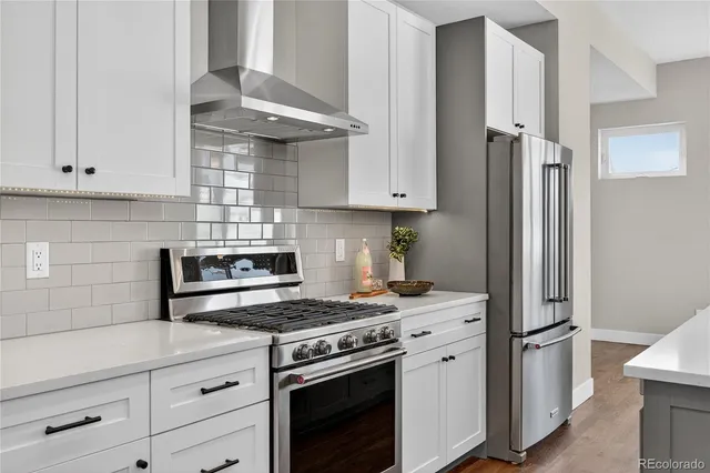 a kitchen with stainless steel appliances white cabinets and a stove