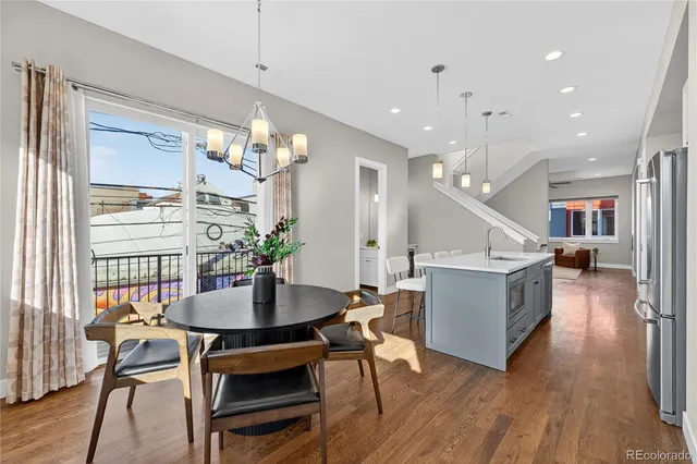 a dining room with furniture and wooden floor