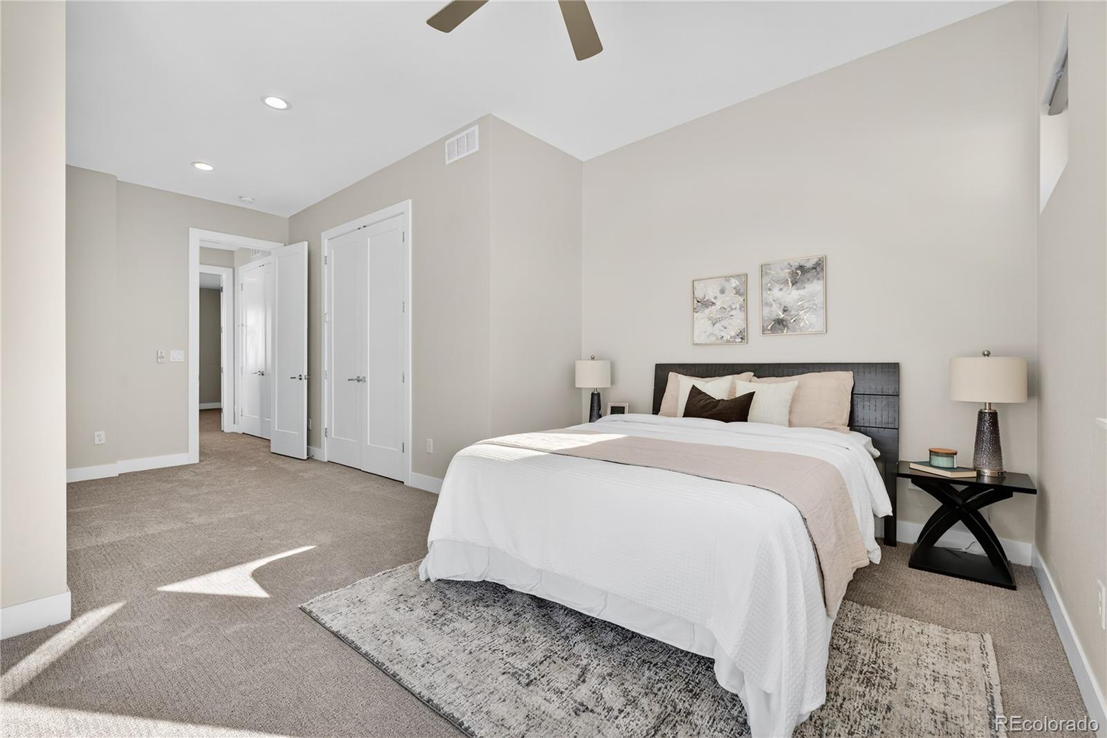 925 Inca Street, Unit 7 Denver, CO 80204 - Photo 23 of 42 a spacious bedroom with a bed and a rug