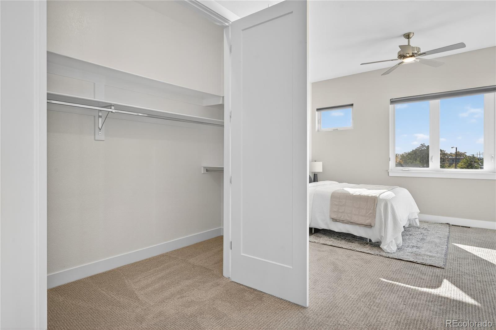 925 Inca Street, Unit 7 Denver, CO 80204 - Photo 25 of 42 a bedroom with a bed and a chandelier