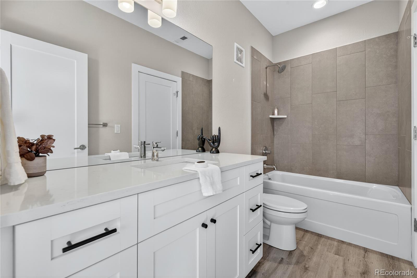 925 Inca Street, Unit 7 Denver, CO 80204 - Photo 8 of 42 a bathroom with a sink a toilet and shower