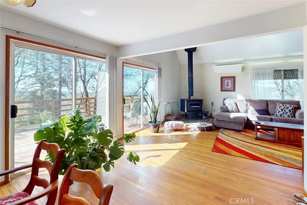 a living room with furniture a flat screen tv and a window