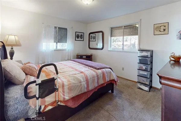 a spacious bedroom with a bed and a large window