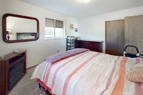 a bedroom with a bed and cabinets