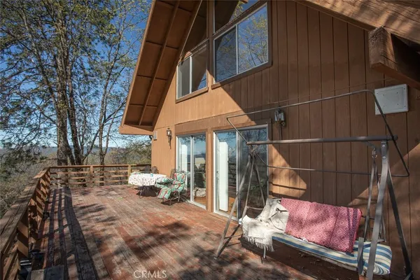 a view of a patio with table and chairs and wooden fence