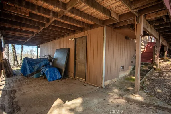 a backyard of a house with barbeque oven table and chairs