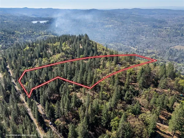 an aerial view of a house with a yard and garage