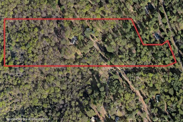 an aerial view of a house with a swimming pool and outdoor seating